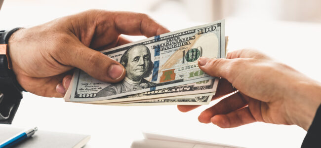 Transfer of money from hand to hand.