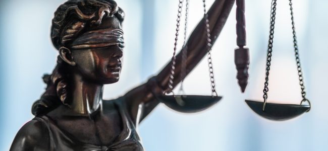 Statue of Justice with scales in lawyer office. Legal law, advice and justice concept