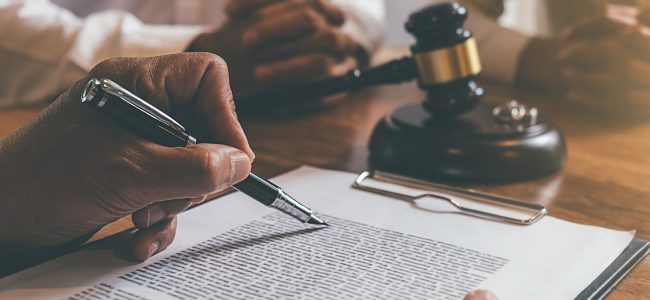 Judge gavel with Justice lawyers deciding, consultation on marriage divorce between married couple and signing divorce documents on table. Concepts of Law and Legal sevices.