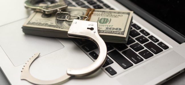 handcuffs; money; crime; financial crime; computer; arrest; dollars